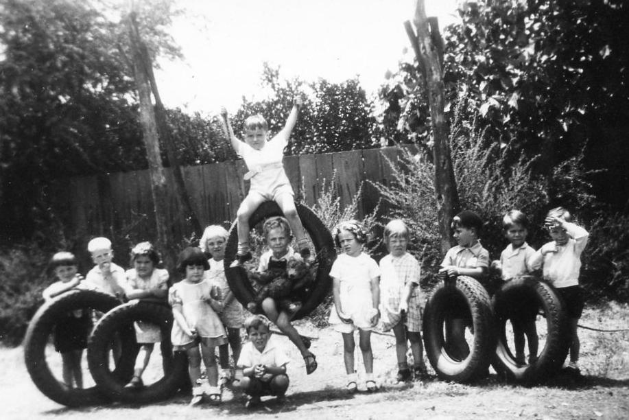 Miss McKeller’s kindergarten in the Collie Methodist Church. The car tire swing with Junior sitting in the tyre with Ted Bear. Elizabeth third from left.
