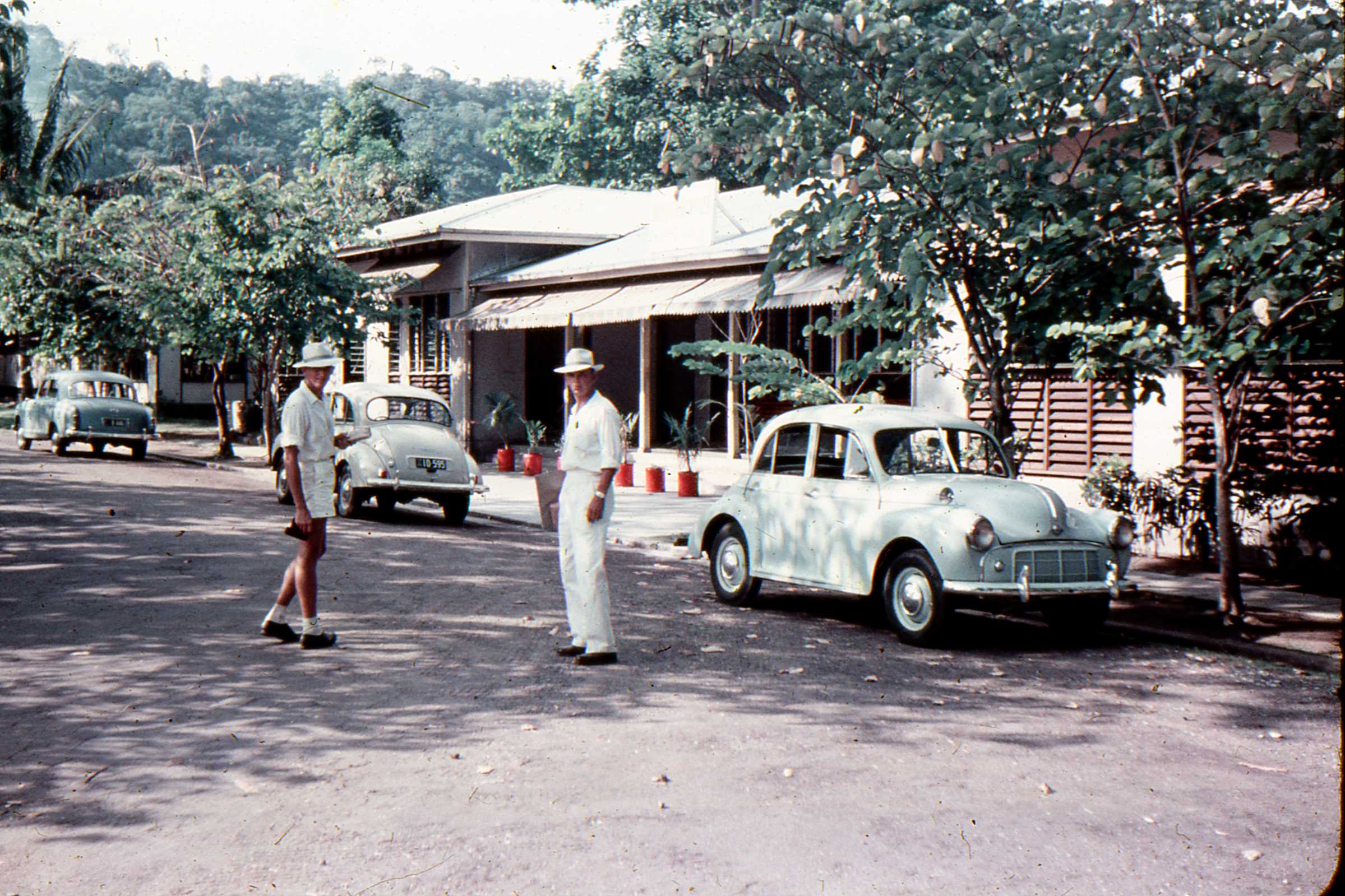 Dressed in our planters whites in the Pen Yang and outside the Cosmopoitan Hotel