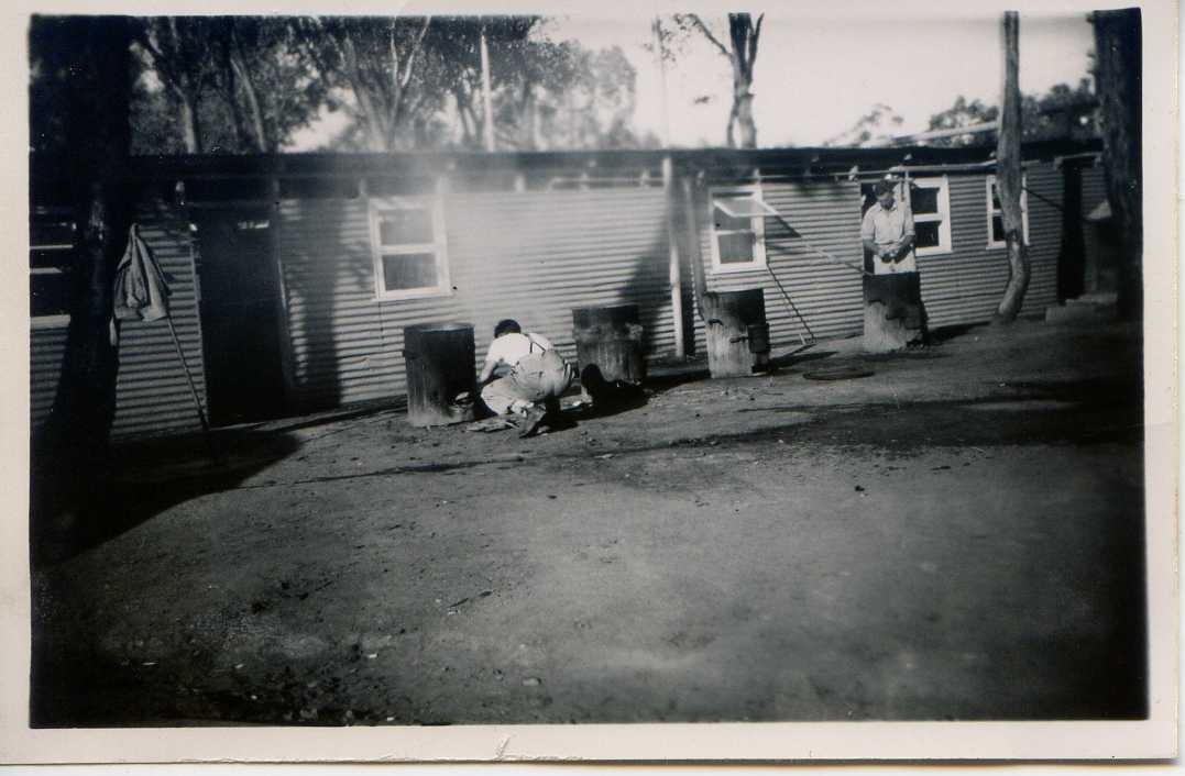 Delta Company wash-house. The wood fired boilers outside were for boiling one’s clothes if only one could find wood to burn