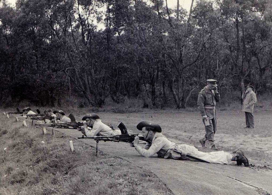 Annual Range Practice on the range at Tyabb or there-abouts. Range officer Capt Bill Child is checking with the butts with CI LtCol Relf standing back.