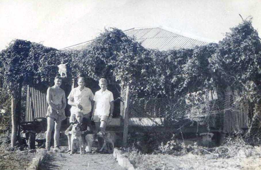 THE HOMESTEAD – Left to right Sergeant Chris Lancaster, Corporal Ted Millar. Sapper Bob Skitch and in front Sapper Sam Chambers with dogs Knuckle and Lassie. ‘Abdul the mascot sits in the vines above