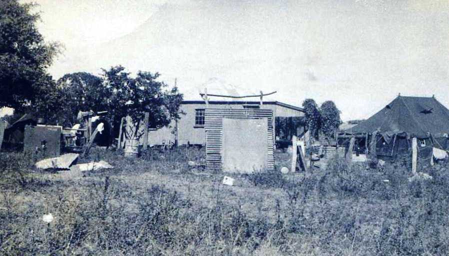 OUR CAMP = Row of tents to left; pissaphone enclosure then showers directly in front and marquee to right. Homestead behind.