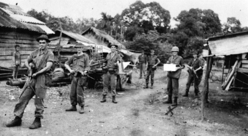 (Photo taken by WO2 Dave Christie) Map annotation in Hoa Long village. Protection provided by C Company 6RAR. Sapper Brian Firns in ‘hard hat’.