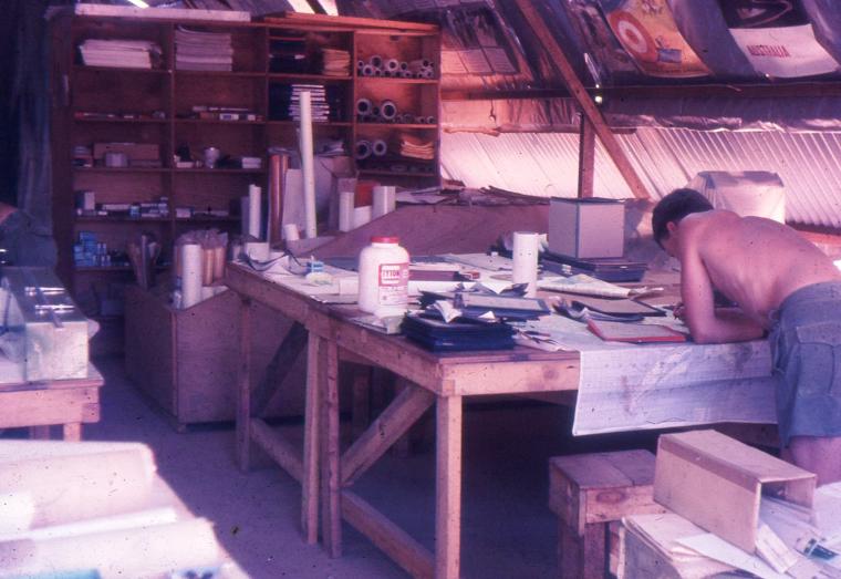 Our general draughting office in Engineer designed tropical work hut. Benches made of US lumber with bond-wood tops. All constructed by Troop personnel.