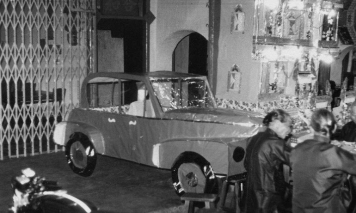 A paper and cardboard car – replica of the prize possession of the deceased. To be taken with him to beyond