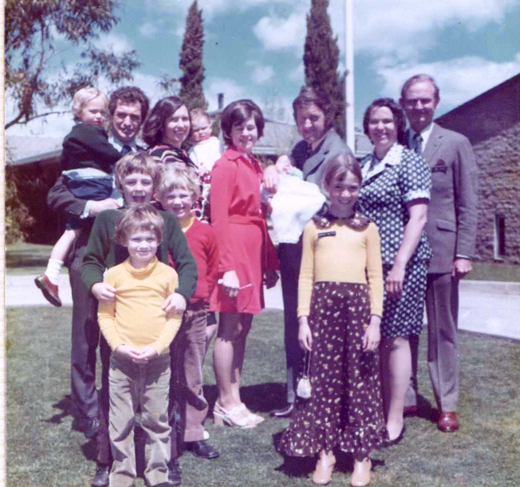 L-R Peter Young holding Robert, Anne holding Genevieve, Myrie Moody, Kevin holding Christopher, Wendy and me. In front – Alex, James and David Young then Sarah.